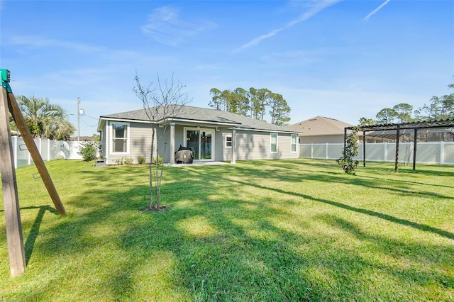 back of property with a lawn and a fenced backyard