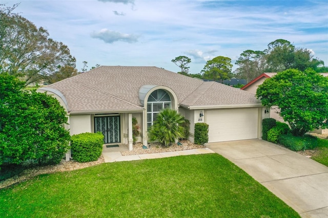 view of front of house with roof with shingles, stucco siding, concrete driveway, an attached garage, and a front lawn