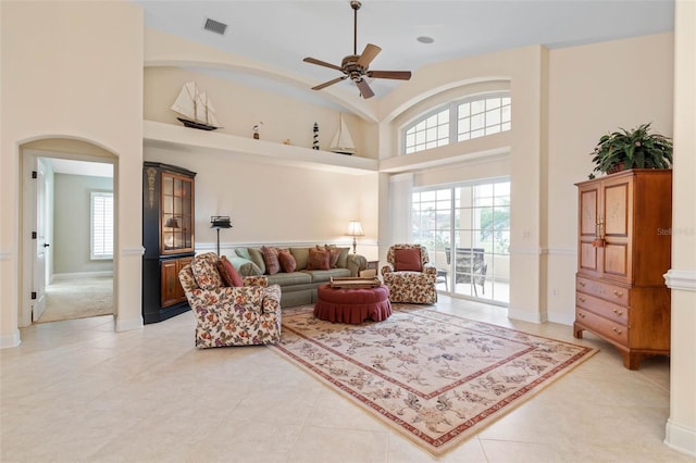 living room featuring a healthy amount of sunlight, high vaulted ceiling, visible vents, and a ceiling fan