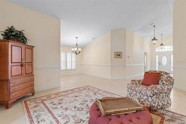 sitting room with arched walkways, light tile patterned floors, an inviting chandelier, vaulted ceiling, and baseboards