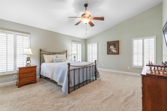 bedroom with lofted ceiling, multiple windows, baseboards, and carpet flooring