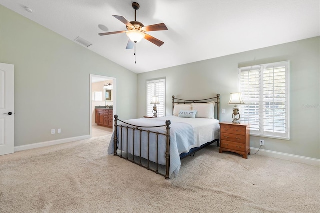 bedroom featuring carpet, visible vents, connected bathroom, vaulted ceiling, and baseboards