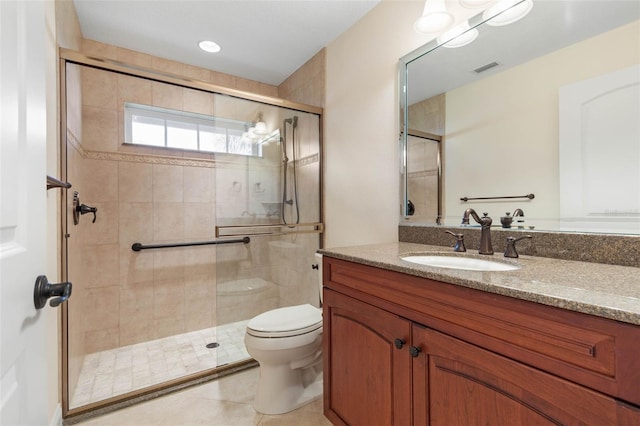 bathroom featuring toilet, a stall shower, tile patterned flooring, and vanity