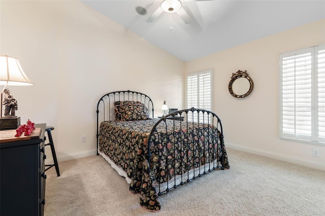 bedroom with a ceiling fan, light carpet, vaulted ceiling, and baseboards