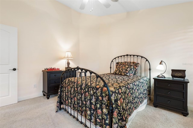 bedroom featuring baseboards, a ceiling fan, and light colored carpet