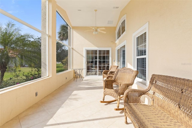 sunroom / solarium featuring ceiling fan