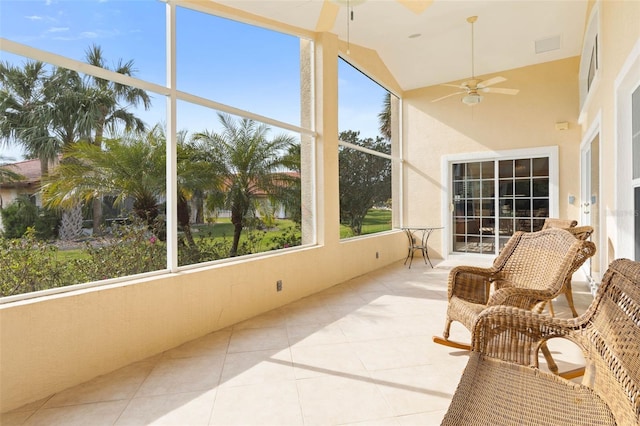 sunroom with ceiling fan, lofted ceiling, and visible vents