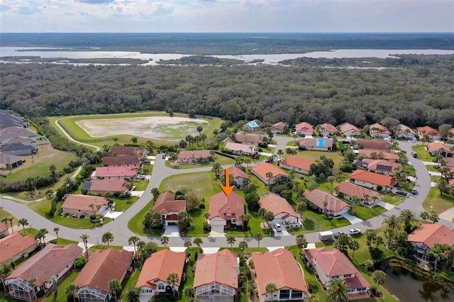 bird's eye view featuring a residential view, a water view, and a view of trees