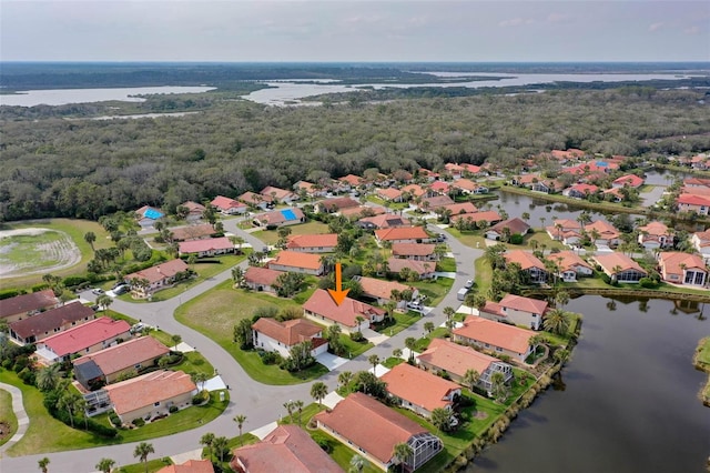 aerial view with a water view, a residential view, and a view of trees