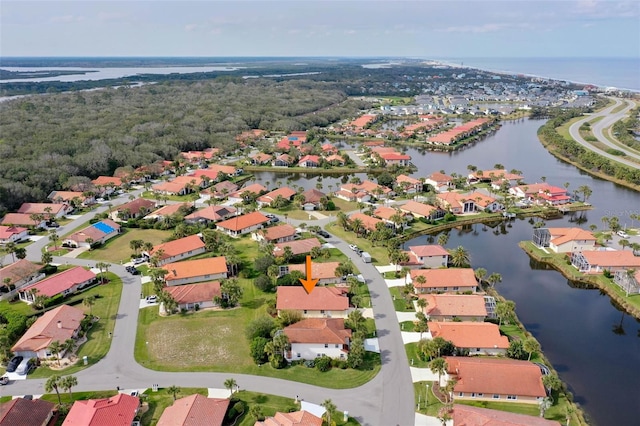 drone / aerial view featuring a water view and a residential view