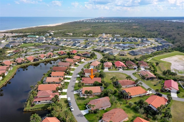 drone / aerial view with a water view and a residential view