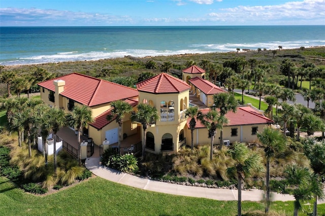 drone / aerial view featuring a water view and a view of the beach