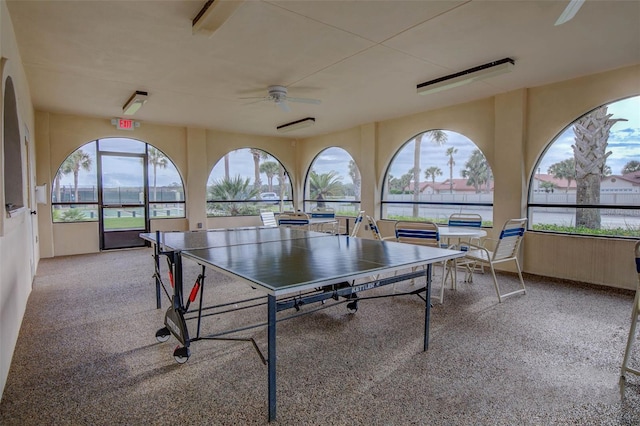 recreation room with carpet floors and a ceiling fan