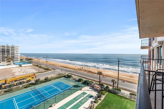 water view featuring a beach view and fence