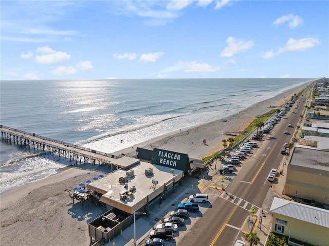 birds eye view of property featuring a water view and a beach view