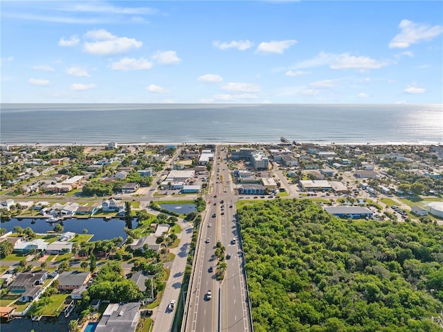 drone / aerial view with a water view and a residential view