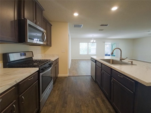 kitchen with visible vents, appliances with stainless steel finishes, dark wood-style flooring, and a sink