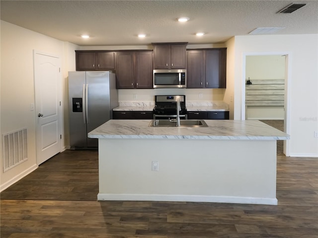 kitchen featuring dark brown cabinetry, visible vents, stainless steel appliances, and a sink