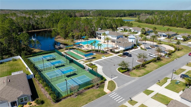 aerial view with a water view and a wooded view