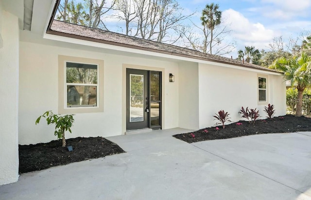 property entrance with stucco siding