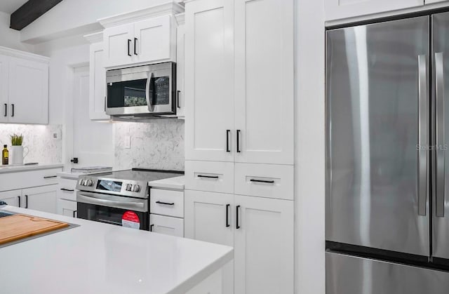 kitchen featuring stainless steel appliances, light countertops, and backsplash