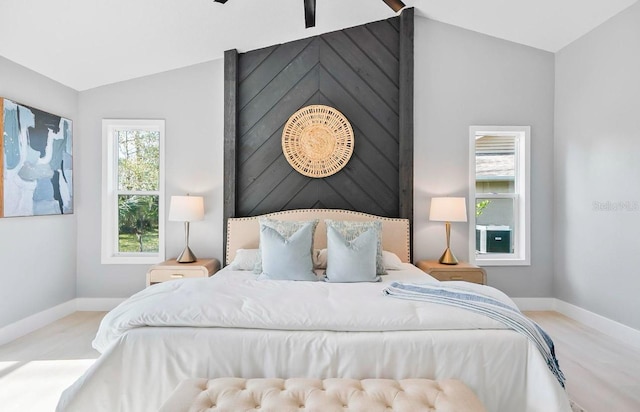 bedroom featuring lofted ceiling and baseboards