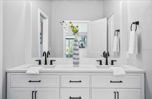 full bath with double vanity and a sink