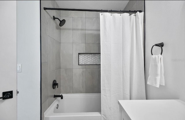 bathroom featuring shower / bath combo with shower curtain and vanity