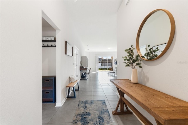 hall with light tile patterned floors and baseboards