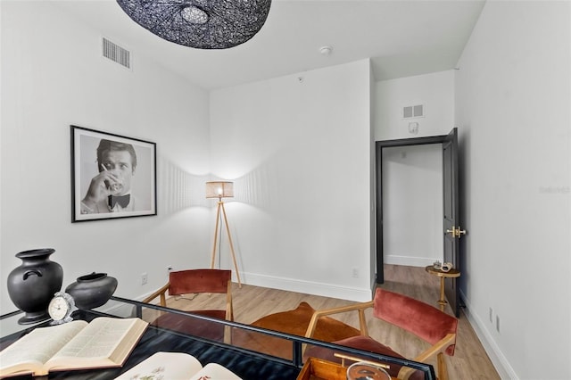 bedroom featuring visible vents, baseboards, and wood finished floors