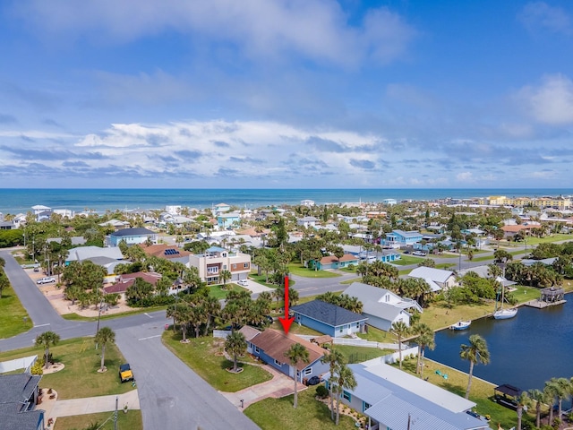 drone / aerial view with a water view and a residential view