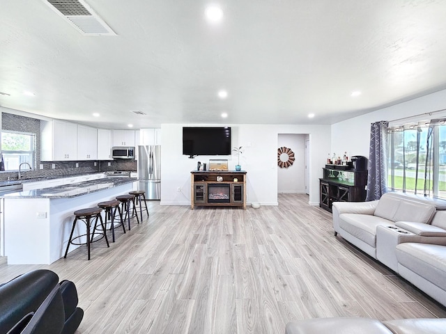 364 Palm Cir, Flagler Beach, FL 32136 - living room with light wood finished floors, baseboards, visible vents, and recessed lighting