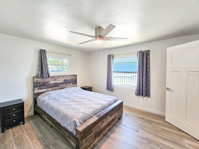364 Palm Cir, Flagler Beach, FL 32136 - bedroom featuring ceiling fan, light wood-style flooring, and baseboards