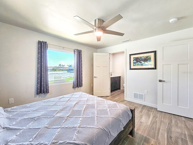 364 Palm Cir, Flagler Beach, FL 32136 - bedroom with visible vents, connected bathroom, light wood-style flooring, and baseboards