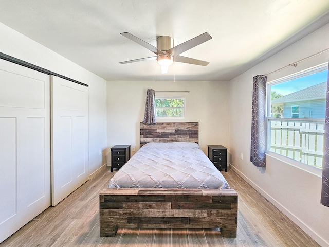 364 Palm Cir, Flagler Beach, FL 32136 - bedroom featuring ceiling fan, a closet, light wood-type flooring, and baseboards
