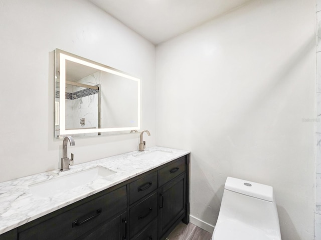 364 Palm Cir, Flagler Beach, FL 32136 - full bath with double vanity, wood finished floors, a sink, and toilet