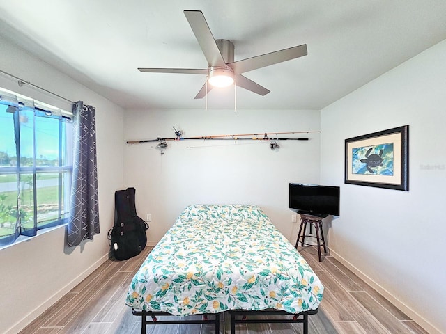 364 Palm Cir, Flagler Beach, FL 32136 - bedroom with wood finish floors, ceiling fan, and baseboards
