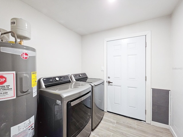 364 Palm Cir, Flagler Beach, FL 32136 - laundry area with light wood-style floors, electric water heater, washer and dryer, laundry area, and baseboards