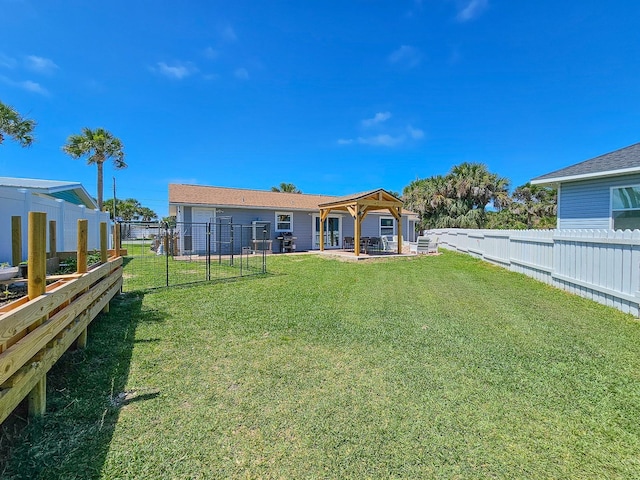 364 Palm Cir, Flagler Beach, FL 32136 - back of property featuring a patio area, a fenced backyard, a yard, and a gazebo