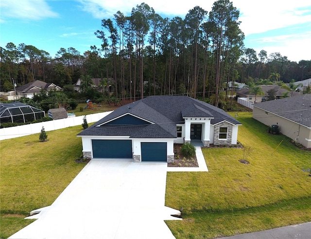 view of front of home featuring a garage, a front yard, stone siding, and concrete driveway