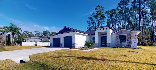 view of front facade with a garage, concrete driveway, stone siding, fence, and a front lawn