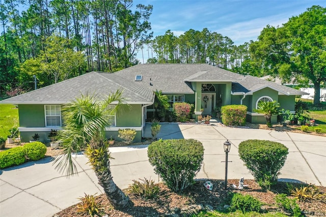 33 Poinsettia Ln, Palm Coast, FL 32164 - single story home featuring stucco siding, a shingled roof, and concrete driveway