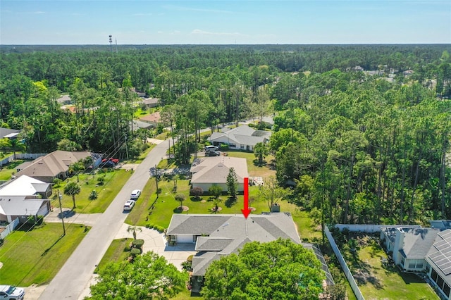33 Poinsettia Ln, Palm Coast, FL 32164 - aerial view of residential area with a heavily wooded area
