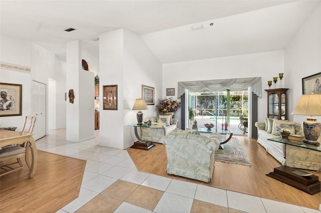 33 Poinsettia Ln, Palm Coast, FL 32164 - living room featuring light tile patterned floors and high vaulted ceiling