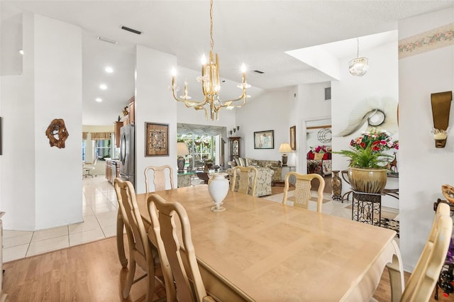 33 Poinsettia Ln, Palm Coast, FL 32164 - dining room featuring a chandelier, light tile patterned floors, and high vaulted ceiling