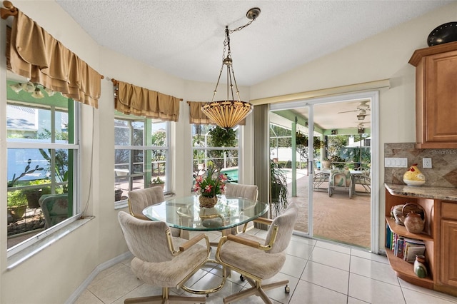 33 Poinsettia Ln, Palm Coast, FL 32164 - dining room featuring light tile patterned flooring, healthy amount of natural light, and a textured ceiling