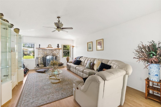 33 Poinsettia Ln, Palm Coast, FL 32164 - living room featuring ceiling fan, light wood-type flooring, and a fireplace