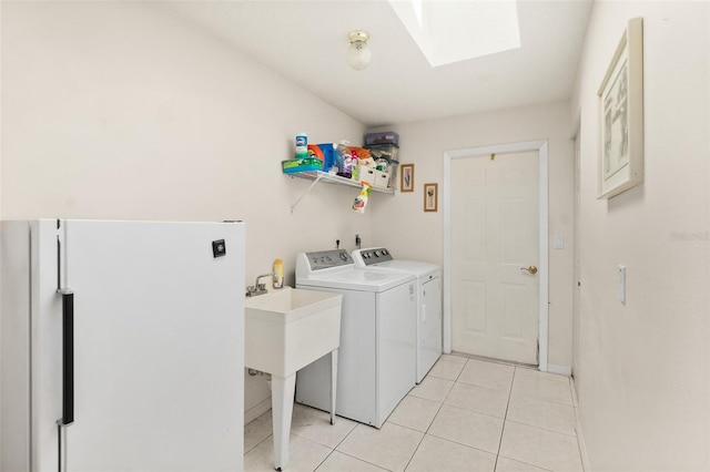 33 Poinsettia Ln, Palm Coast, FL 32164 - laundry room featuring a skylight, washer and clothes dryer, and light tile patterned floors