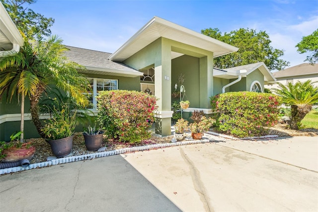 33 Poinsettia Ln, Palm Coast, FL 32164 - view of exterior entry with stucco siding