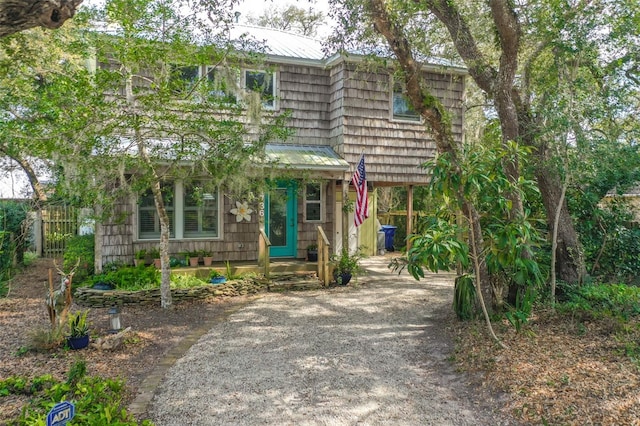 view of front of house featuring metal roof and gravel driveway